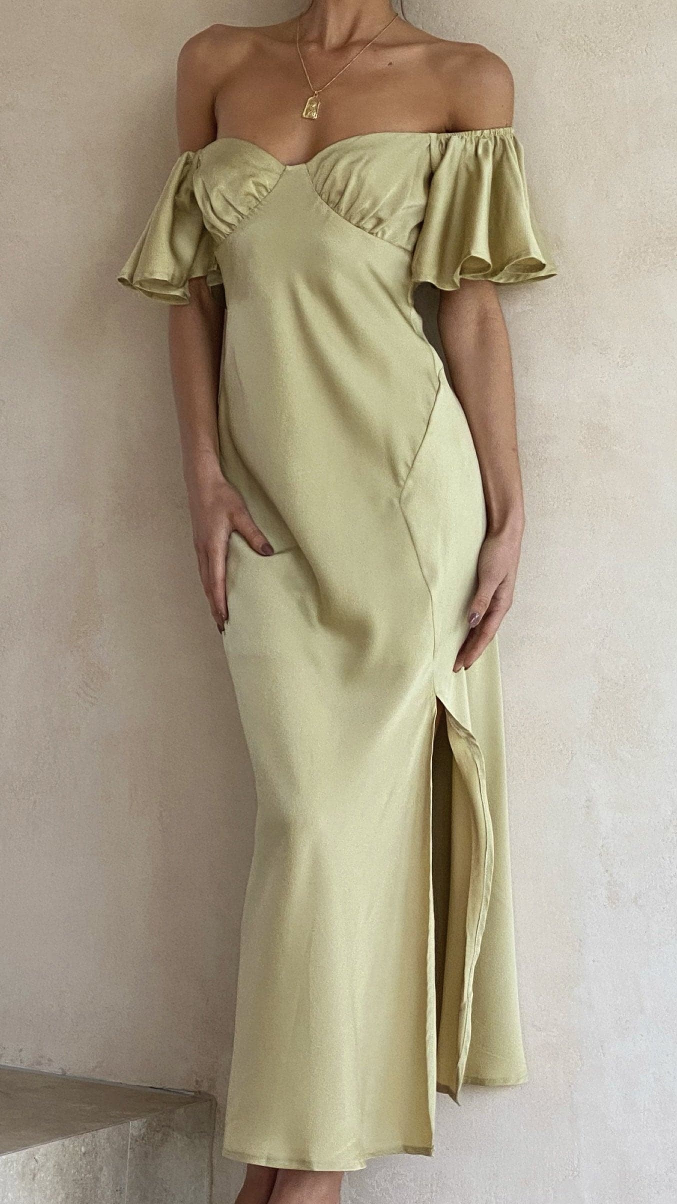 Off-shoulder ruffle midi dress in pale yellow with curved neckline and slit