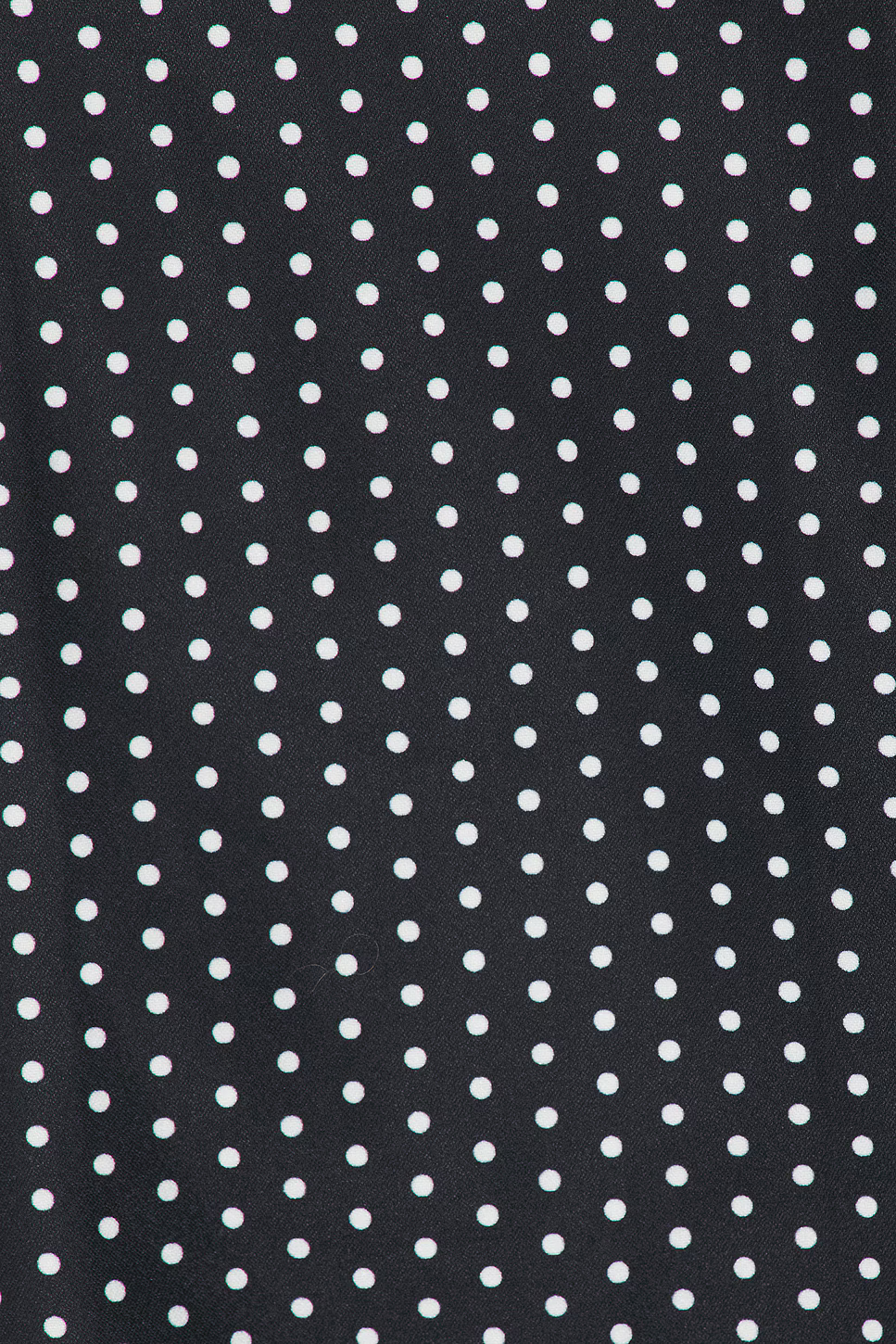 White polka dot pattern detail on black fabric of mini dress