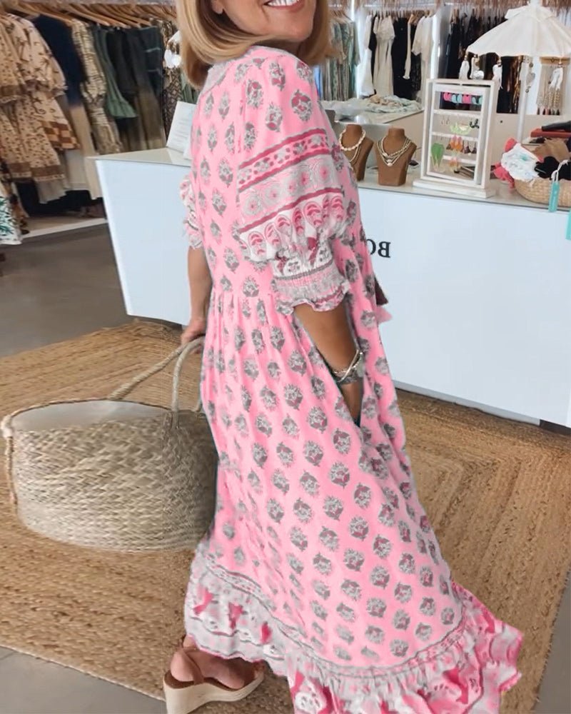 Back view of pink tiered maxi dress displaying ruffled layers and floral pattern