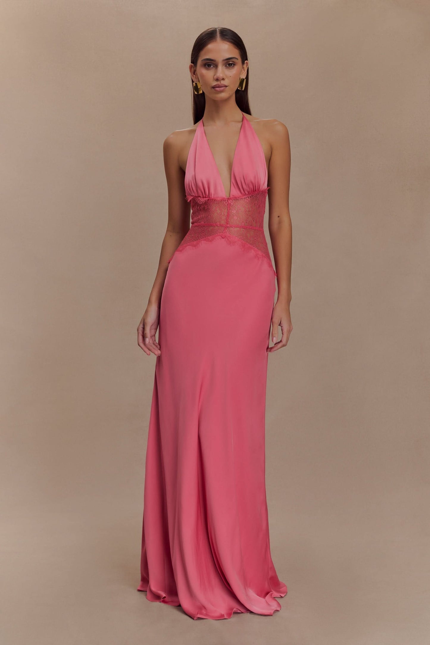 Front view of pink halter maxi dress with ornate lace waist detail
