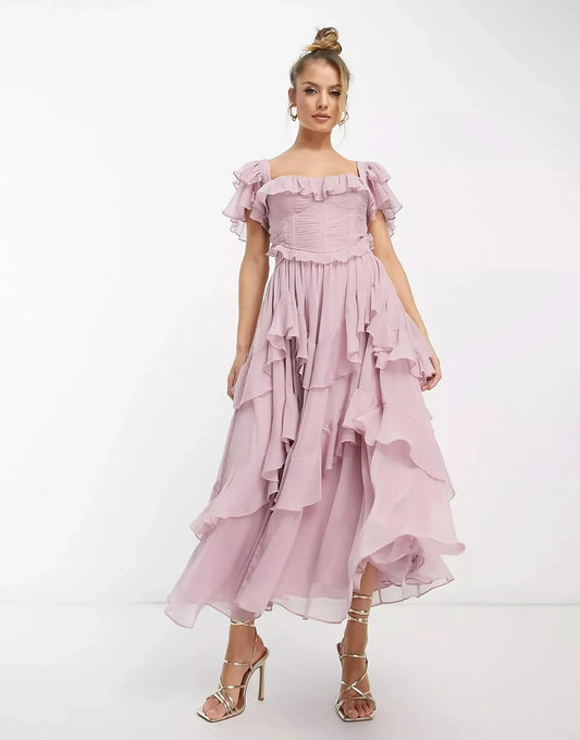 Blush pink ruffle midi dress with off-shoulder neckline and layered skirt