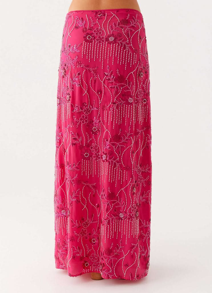 Close-up of pink sequin maxi skirt showing beaded floral motif