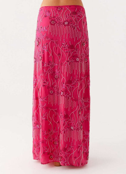 Close-up of pink sequin maxi skirt showing beaded floral motif