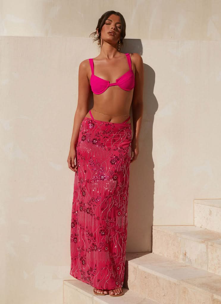 Full-length pink sequin maxi skirt styled with matching bikini top