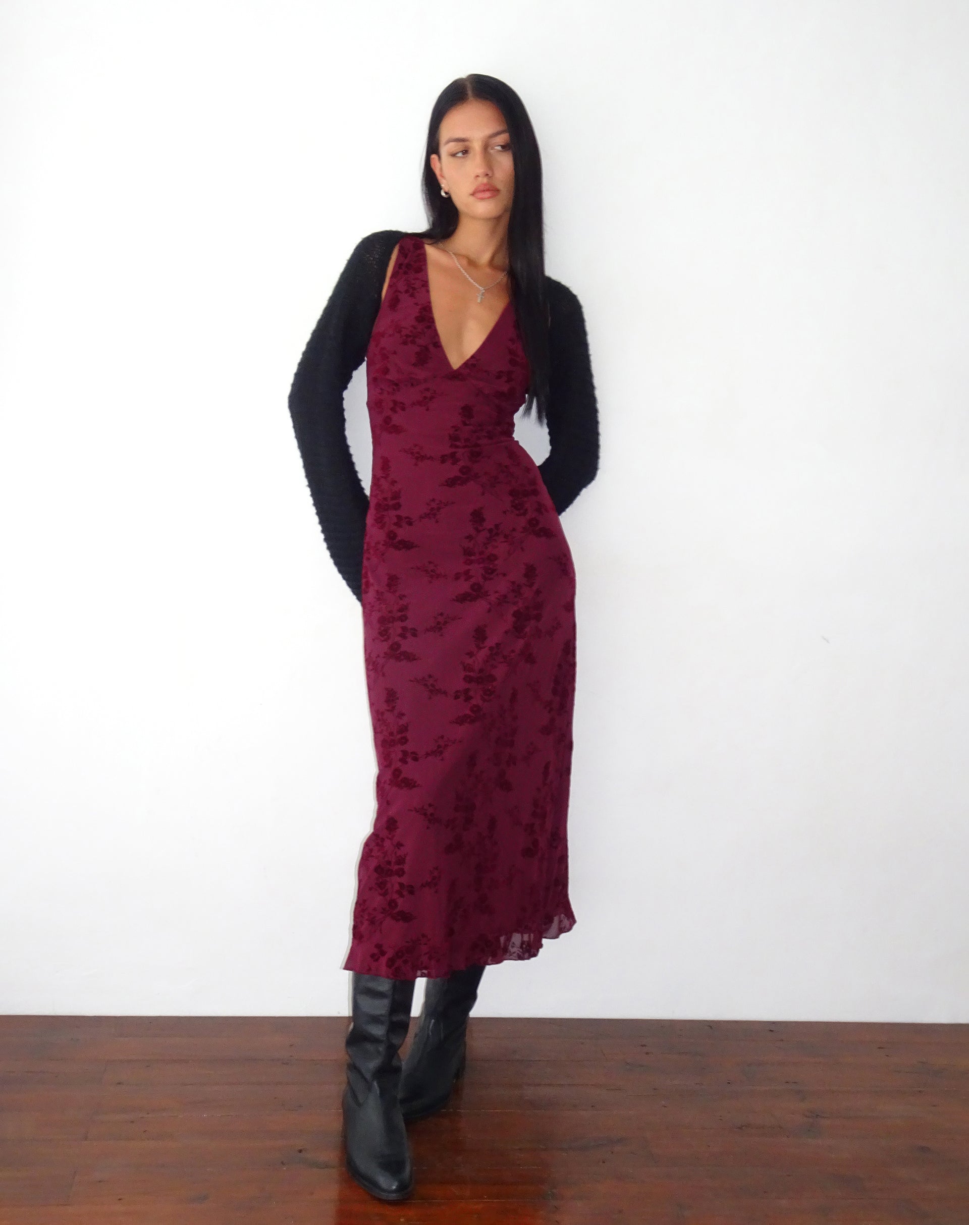 Burgundy floral velvet midi dress styled with black cardigan and boots
