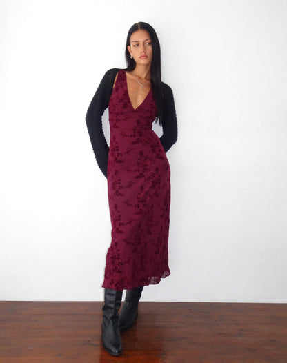 Burgundy floral velvet midi dress styled with black cardigan and boots