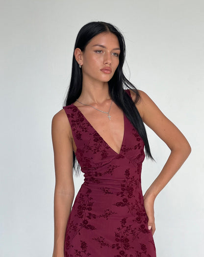 Close-up of burgundy velvet midi dress showing floral burnout texture and wrap neckline