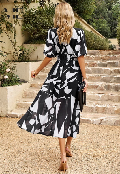 Back view of black white floral midi dress with puff sleeves