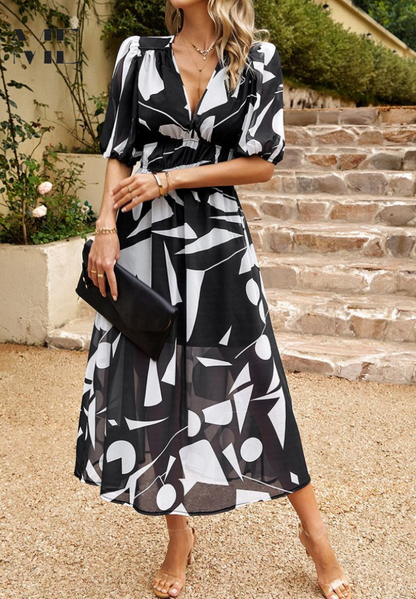 Black and white abstract pattern midi dress with cinched waist and flowing skirt