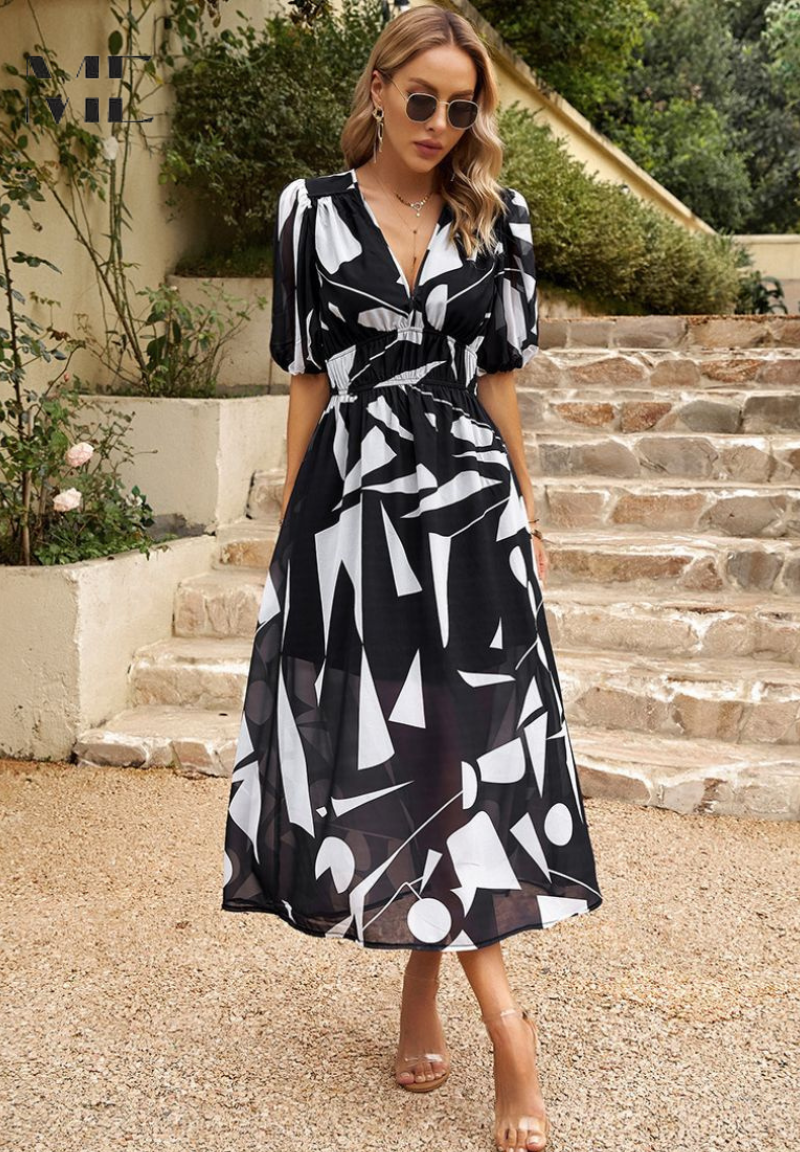 Black and white geometric print midi dress with wrap neckline and short sleeves