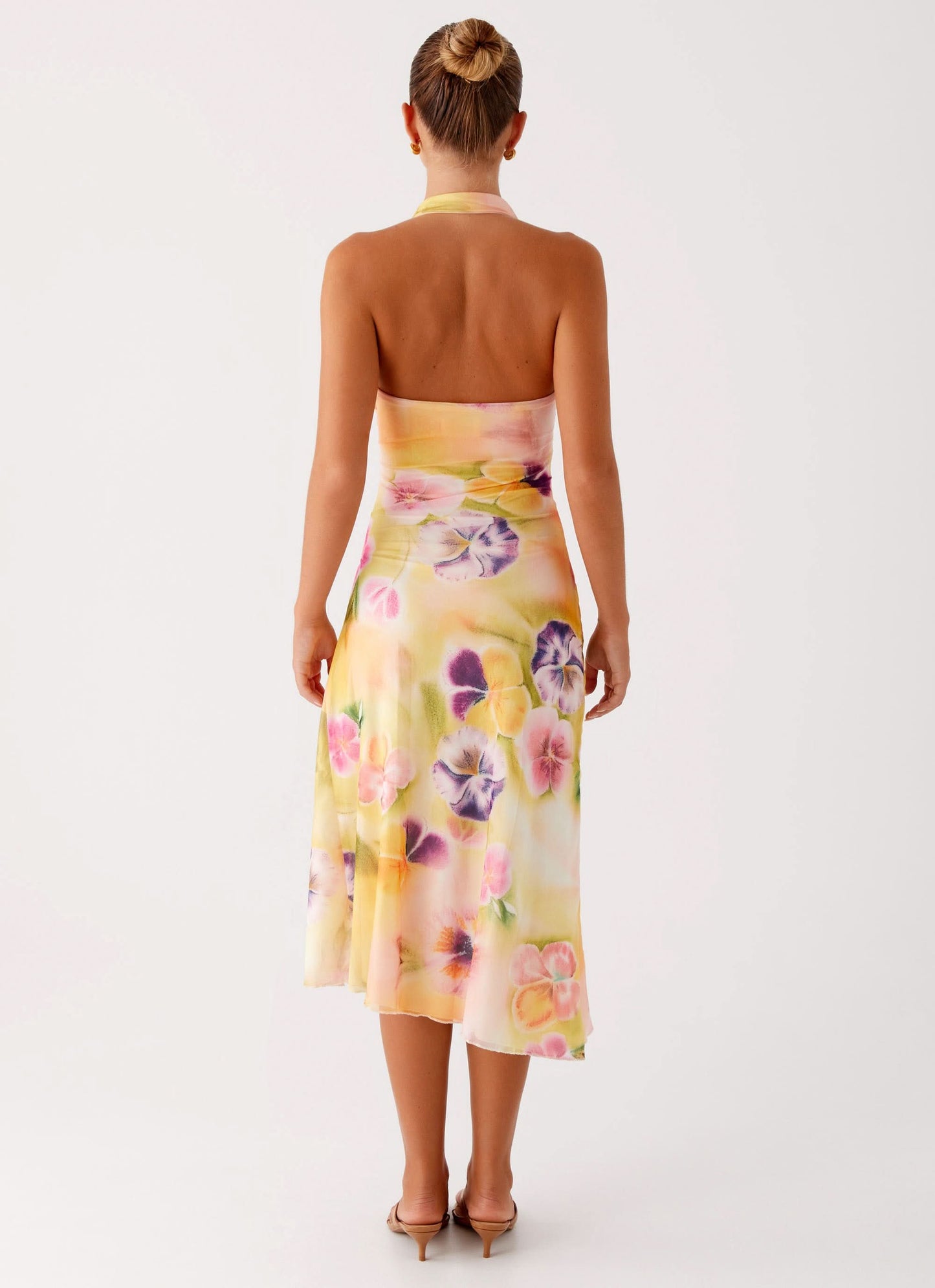 Back view of floral wrap midi dress with tie halter detail
