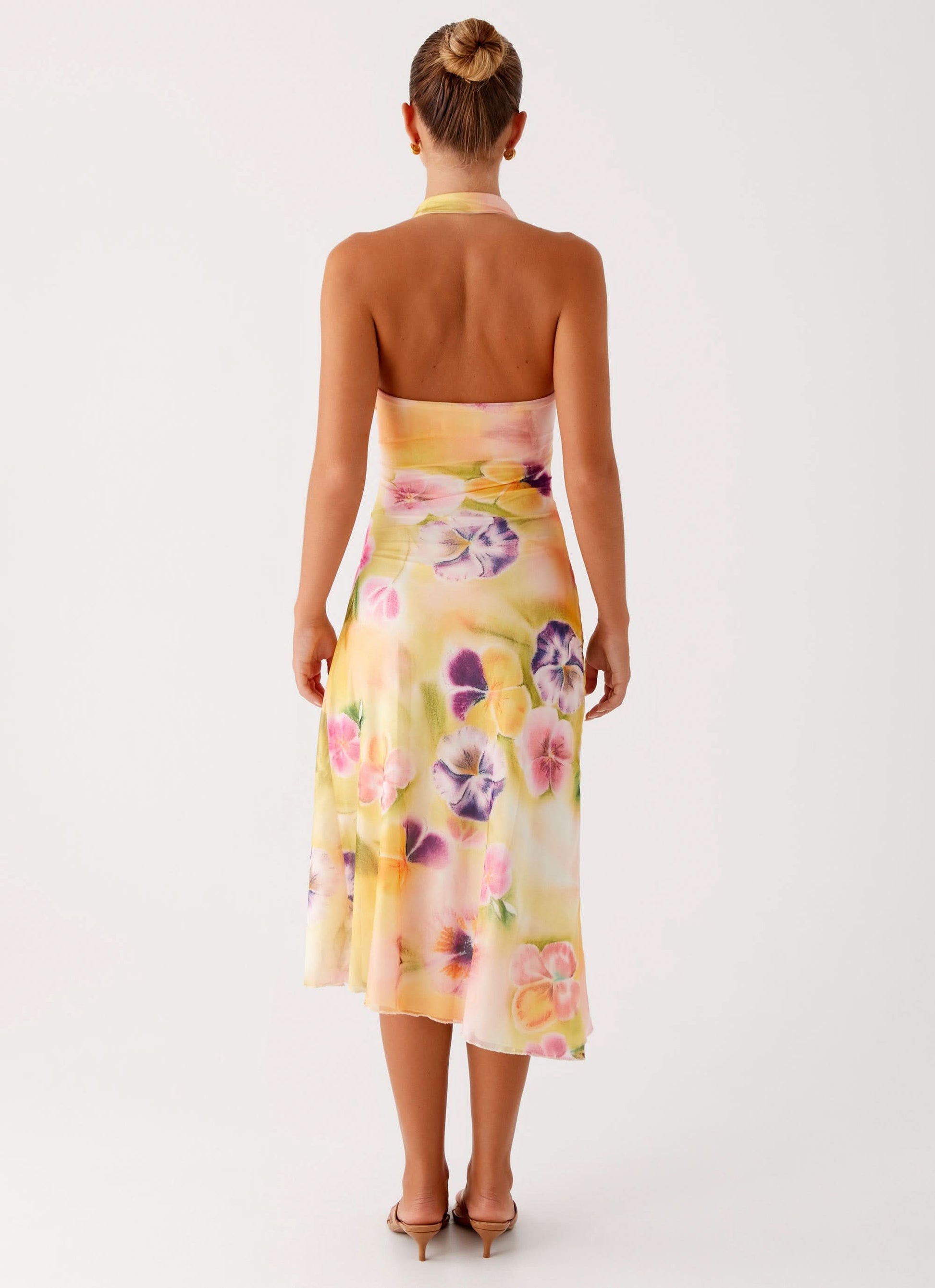 Back view of floral wrap midi dress with tie halter detail
