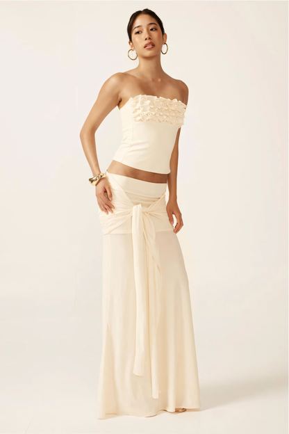 Cream strapless ruched crop top with textured ruffle neckline and matching maxi skirt with tie waist