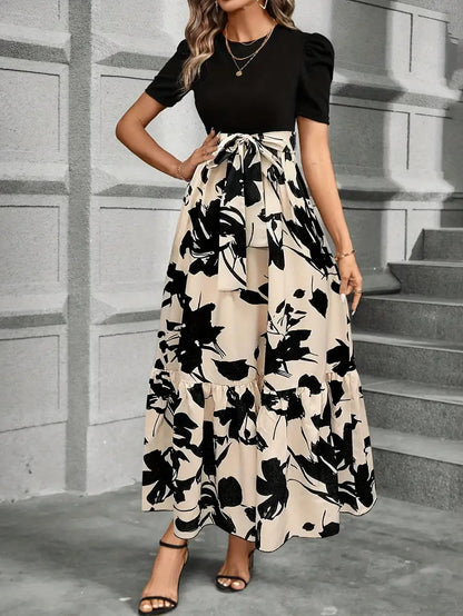 Fitted black top with adjustable tie waist and flowing floral maxi skirt detail