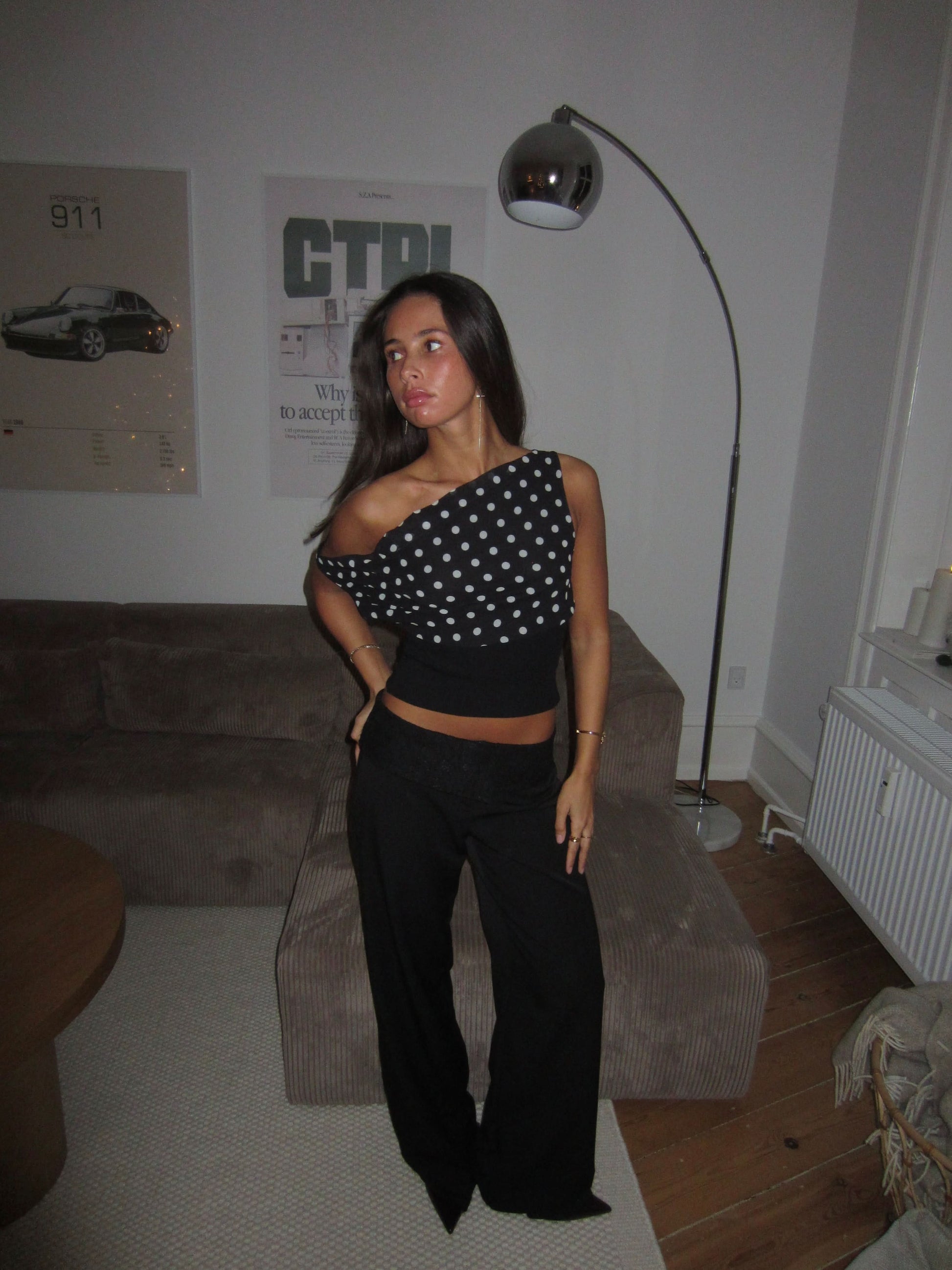 Back view of black polka dot crop top showing lace-up detail
