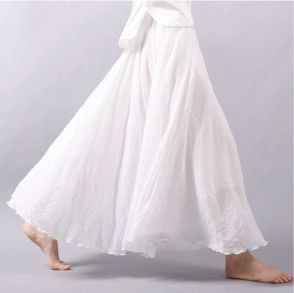 White pleated maxi skirt side view with full skirt movement
