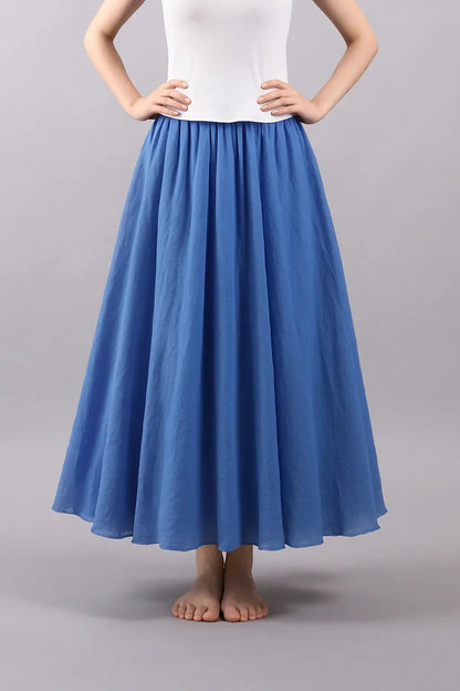 Blue pleated maxi skirt front view with structured waist detail