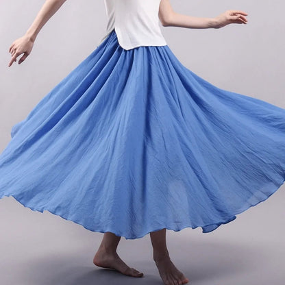 Blue pleated maxi skirt in motion showing graceful drape