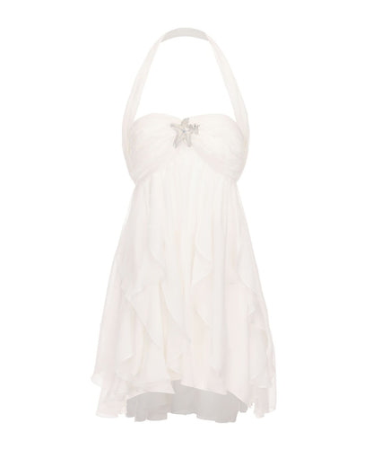 Cream halter mini dress with ruffled skirt and star brooch detail
