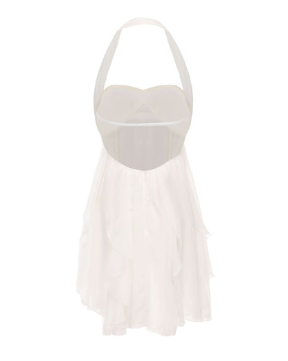 Back view of cream halter dress showing open back and layered ruffle skirt