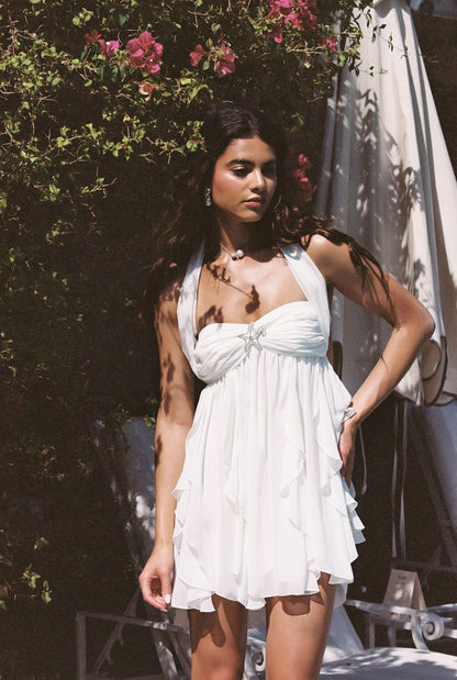 Cream halter mini dress with cascading ruffles and gathered bodice detail