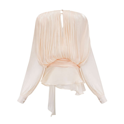 Back view of cream mini dress with gathered ruffle cape and tie detail