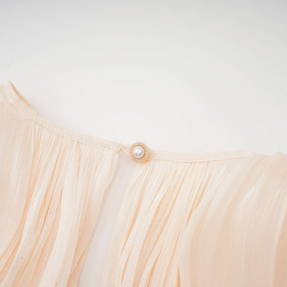 Pearl button detail on cream pleated ruffle dress waist tie