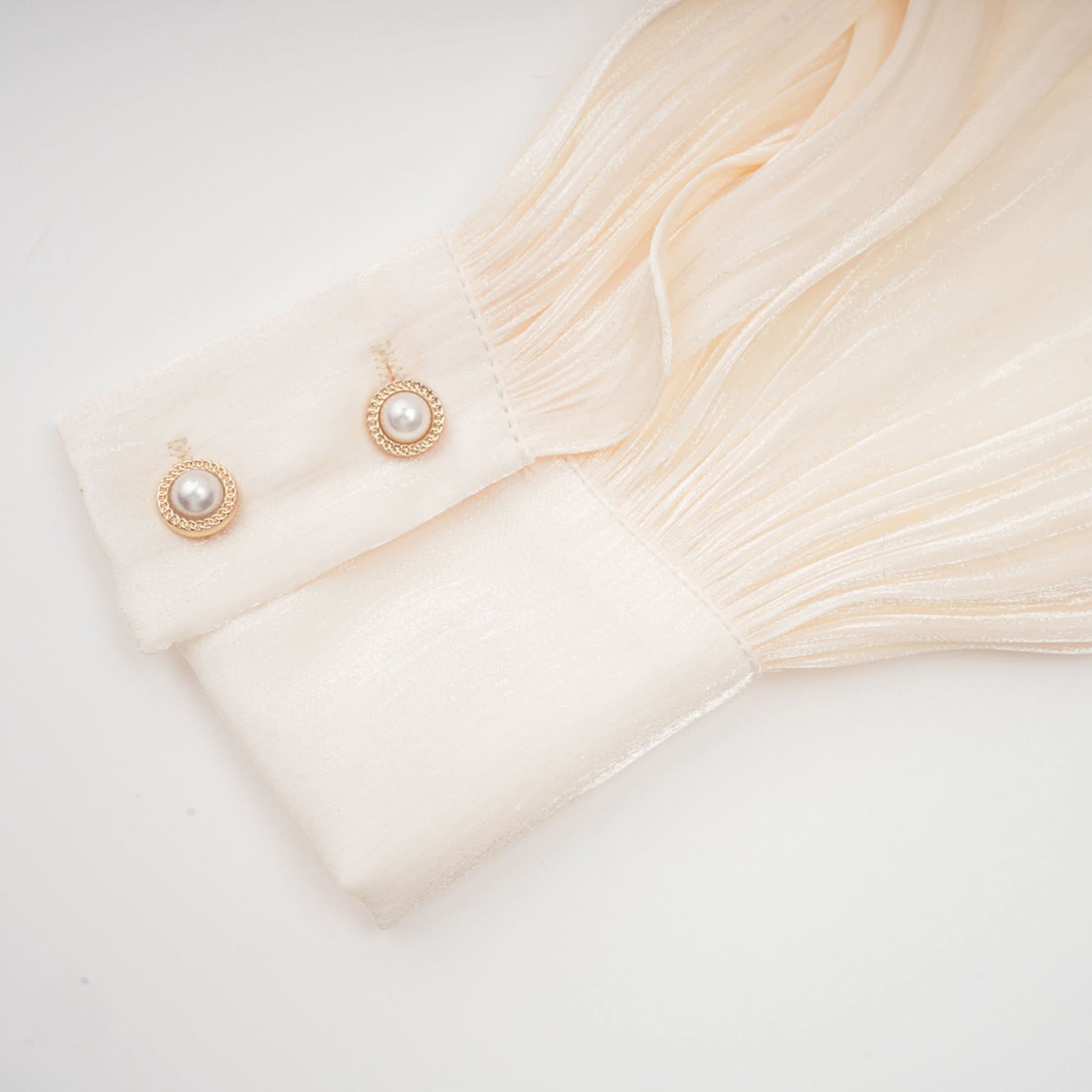 Flowing cream pleated ruffle hem with delicate layered edges