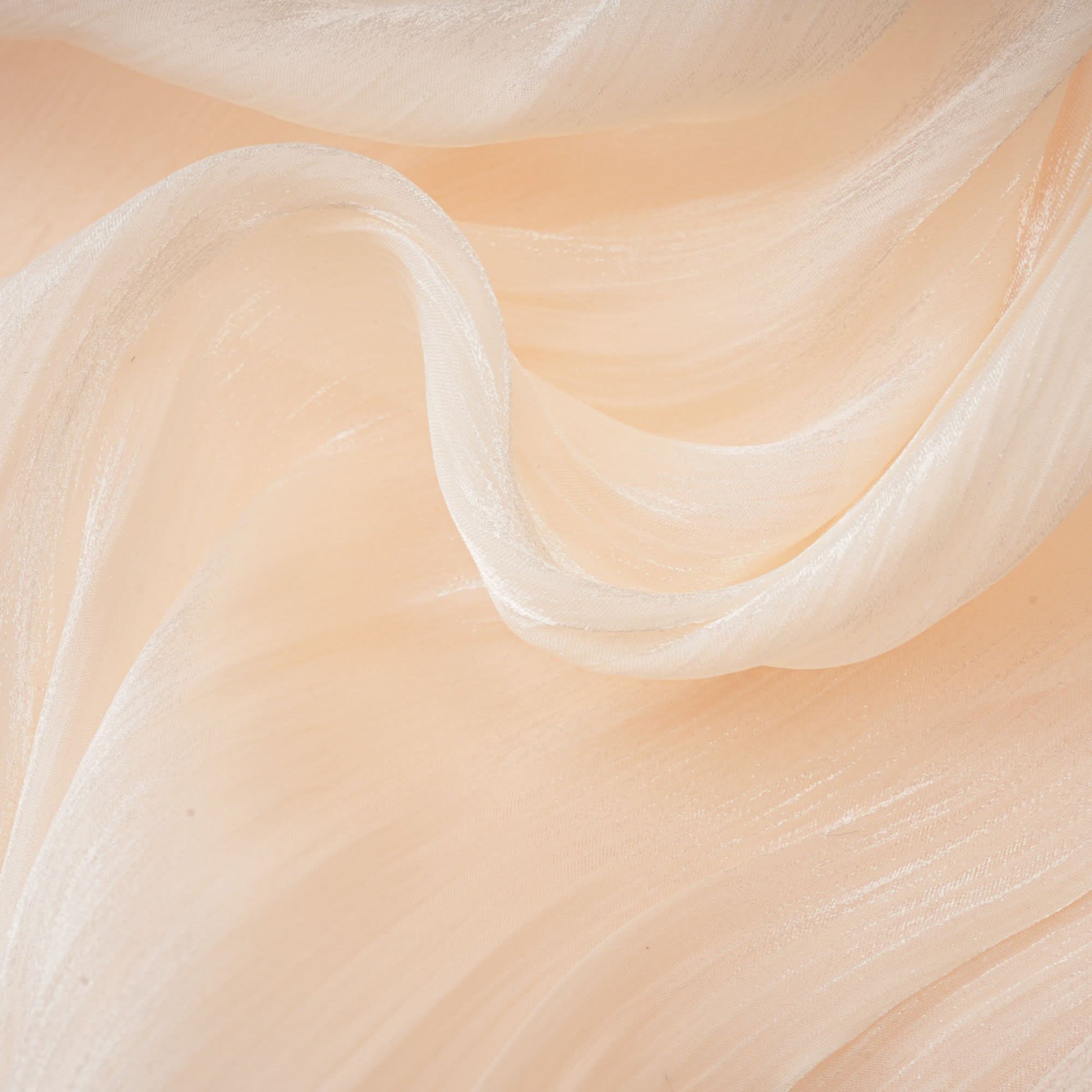 Layered ruffle edge on cream mini dress showing soft fabric drape