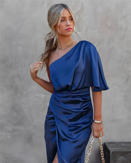 Back view of navy blue draped midi dress with flutter cape sleeve and fitted ruched bodice