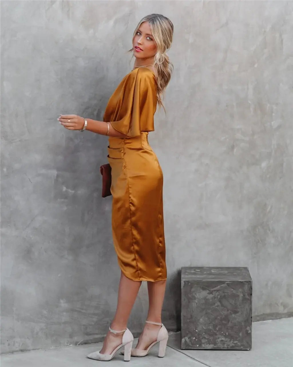 Gold one-shoulder draped midi dress with asymmetrical neckline and side slit