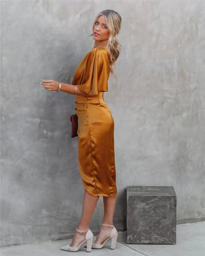 Gold one-shoulder draped midi dress with asymmetrical neckline and side slit