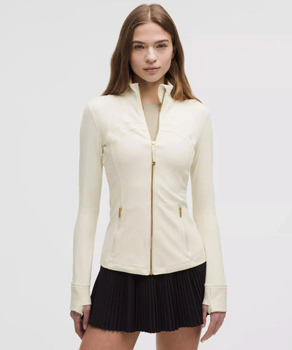 Cream contoured zip jacket with gold accents and side waist pockets