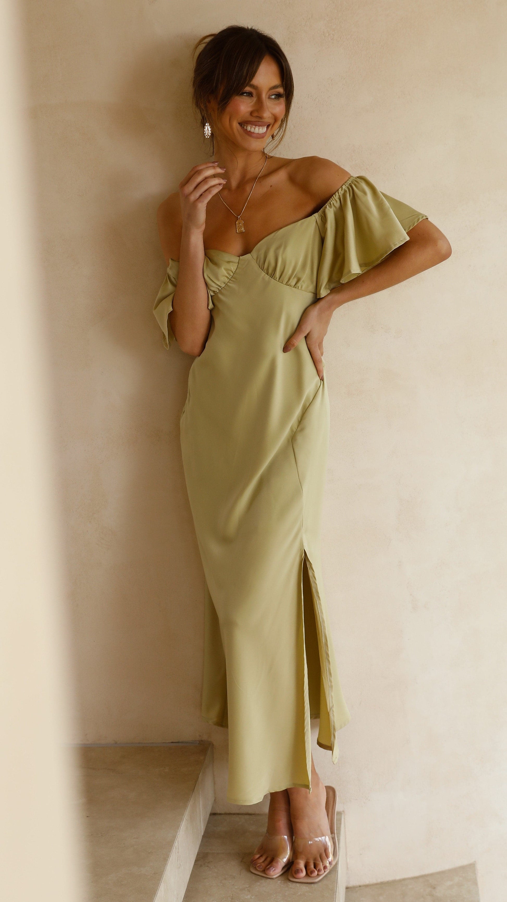 Cream ruffle midi dress with off-shoulder design and flutter sleeve detail side angle