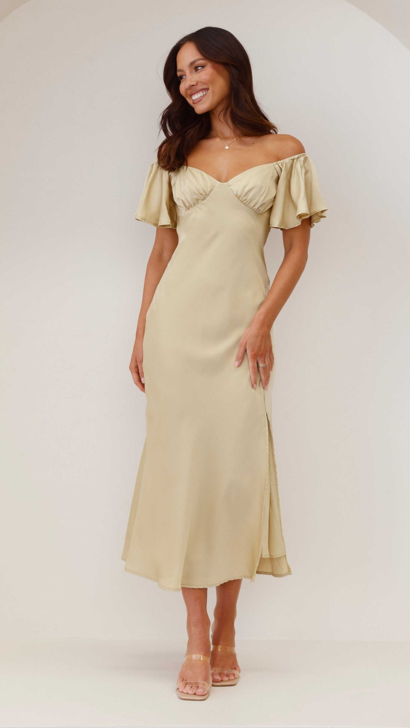 Outdoor view of sage green ruffle midi dress with off-shoulder flutter sleeves