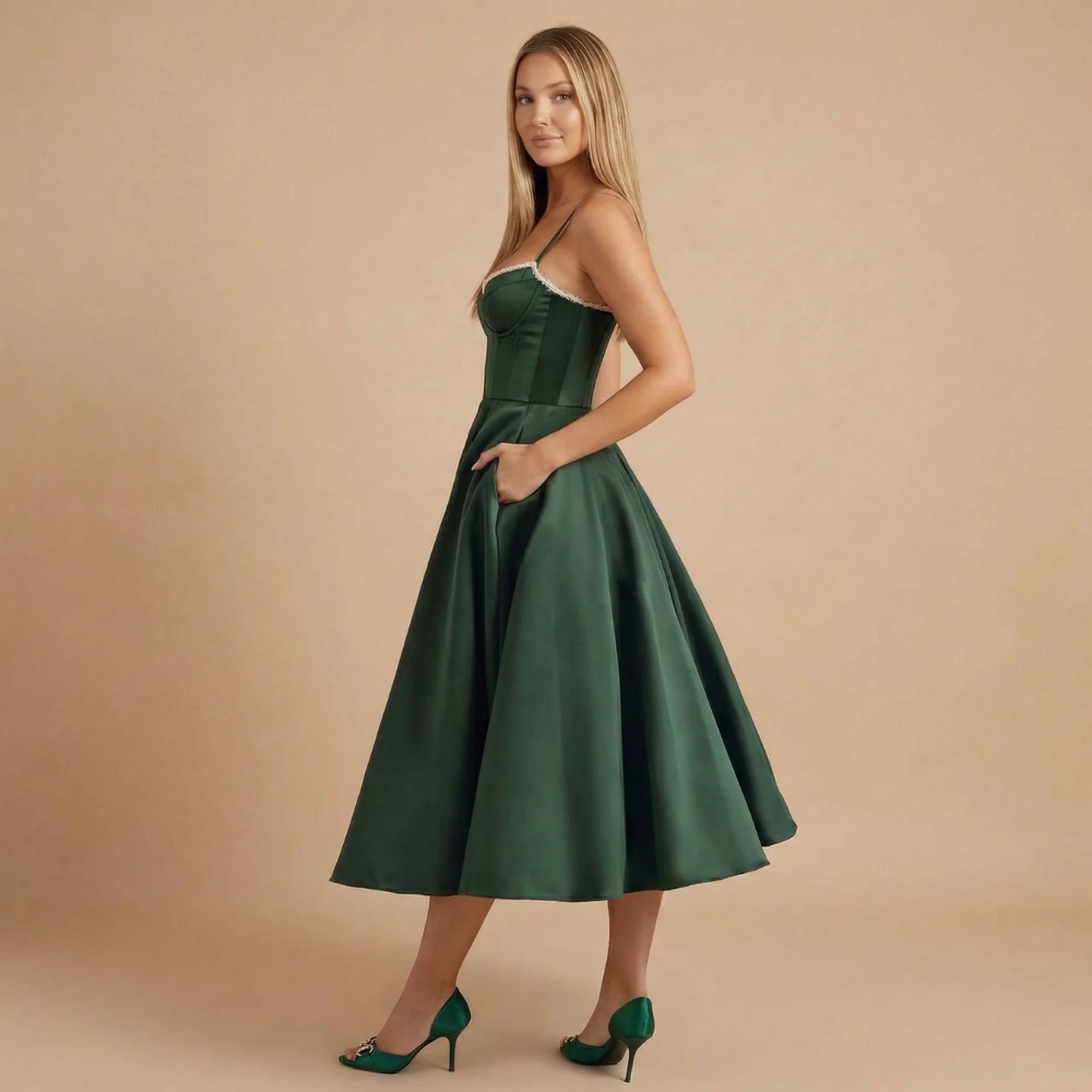Side view of dark green midi dress with spaghetti straps and pocket detail
