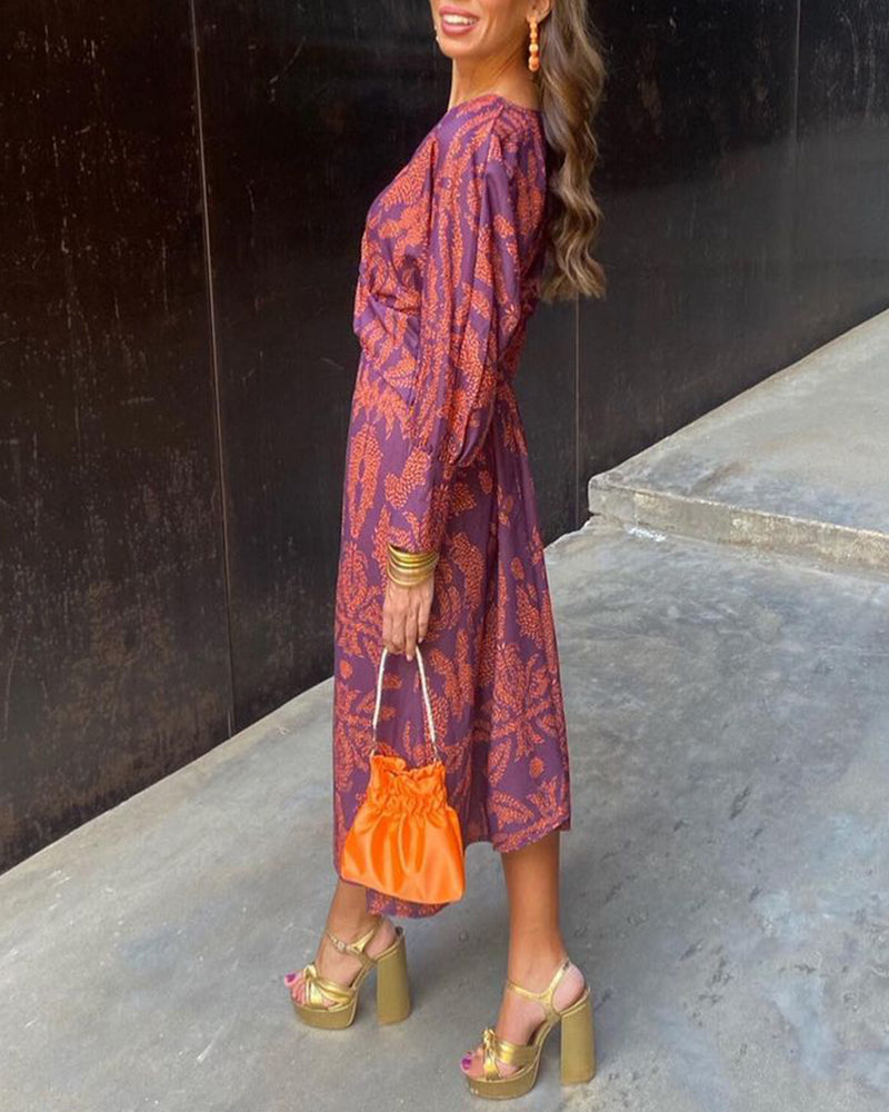 Purple wrap midi dress with rust leaf print, back view showing wrap silhouette