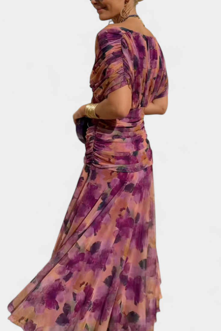 Back view of purple floral maxi dress showing ruched waist and flowing skirt