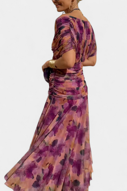 Back view of purple floral maxi dress showing ruched waist and flowing skirt