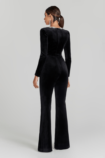 Back view of black velvet jumpsuit with flared legs and crystal-trimmed square neckline