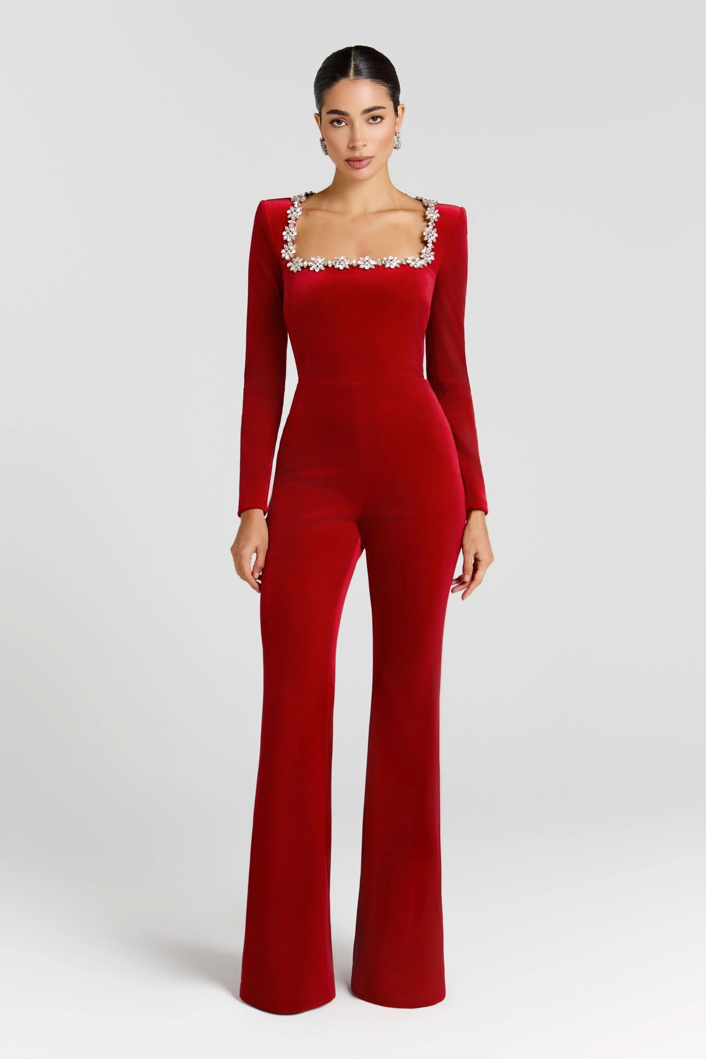 Red velvet square-neck jumpsuit with crystal-embellished neckline and long fitted sleeves
