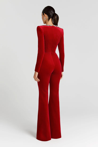 Back view of red velvet jumpsuit with flared legs and crystal-trimmed square neckline