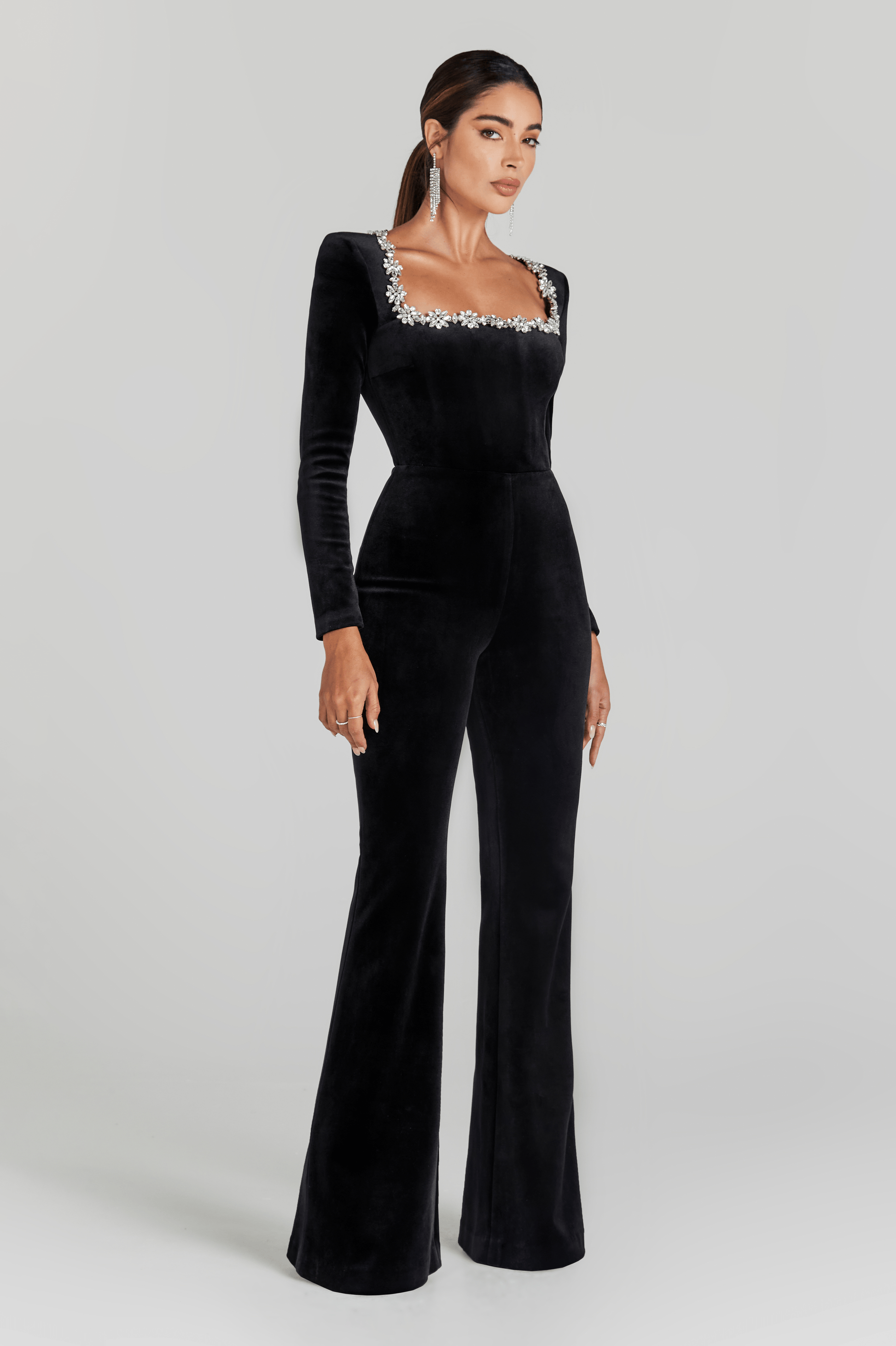 Black velvet square-neck jumpsuit with crystal-embellished neckline and long sleeves