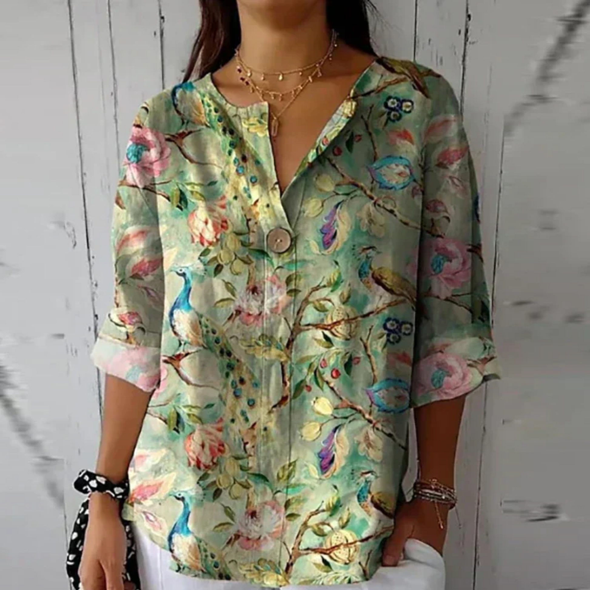 Vibrant lime and pink floral 3/4 sleeve top with bold watercolor flower design