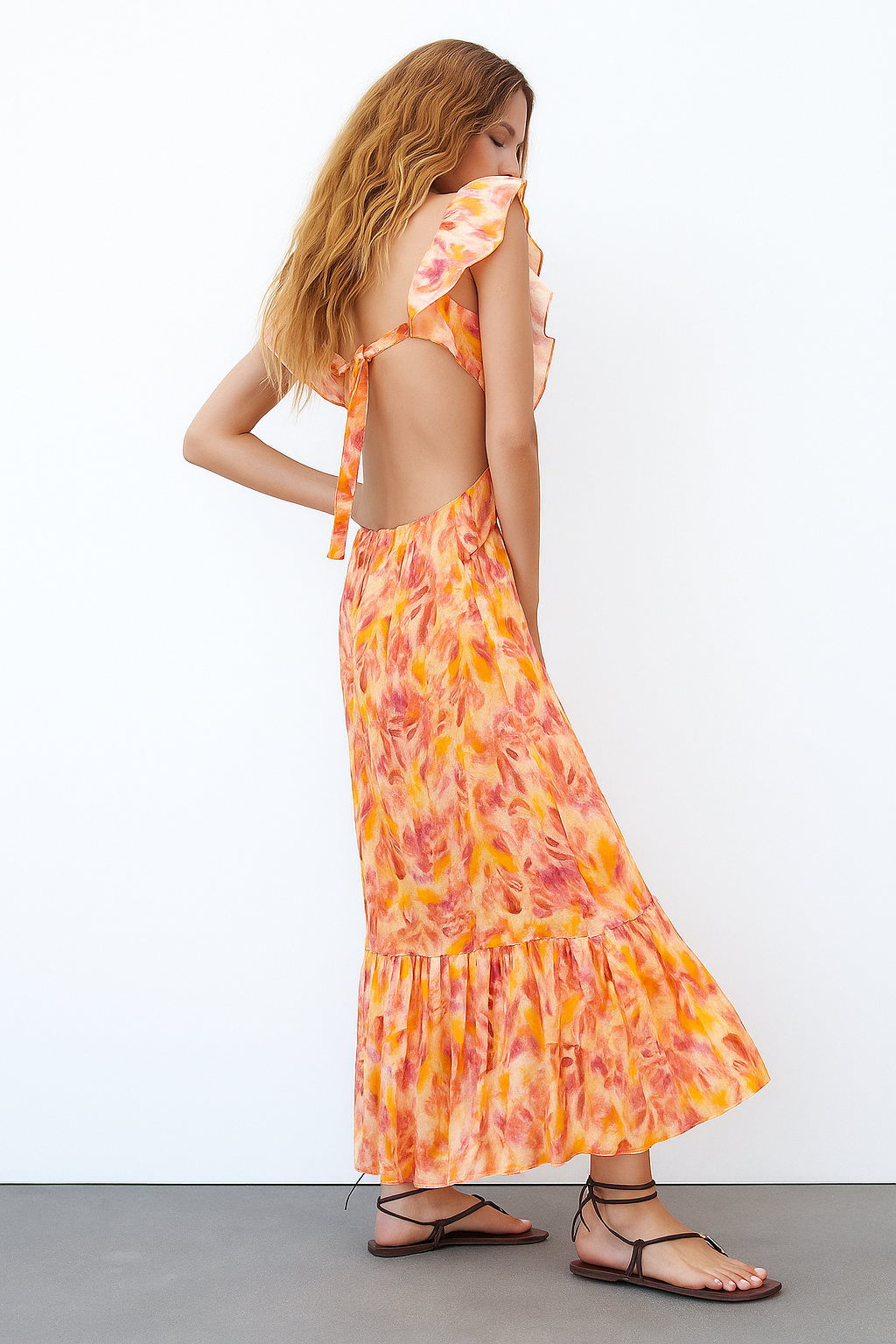 Watercolor floral maxi dress with open tie-back closure and tiered hem detail