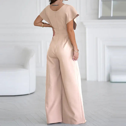 Blush pink wrap jumpsuit back view with short puffed sleeves