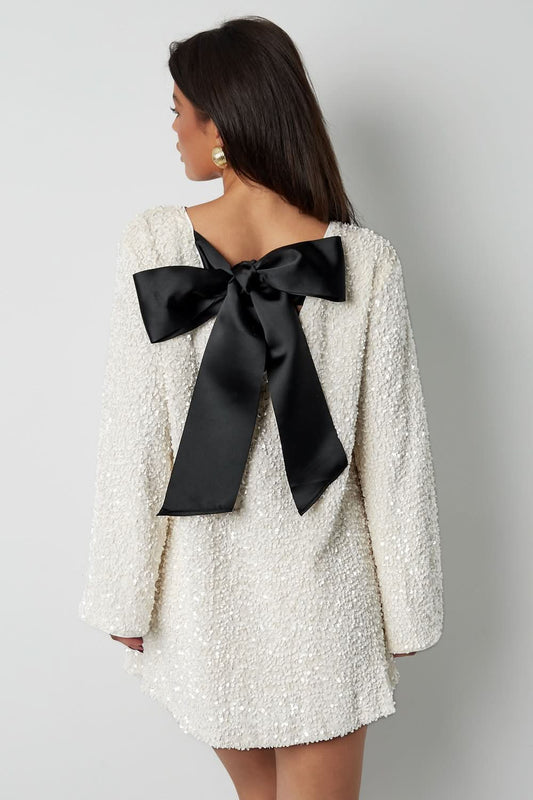 Cream textured mini dress with black bow detail on back