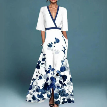 White maxi dress with navy blue floral print, wrap V-neck, and front slit detail