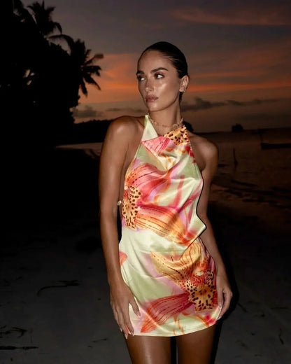 Cream floral halter mini dress with draped neckline on woman at sunset