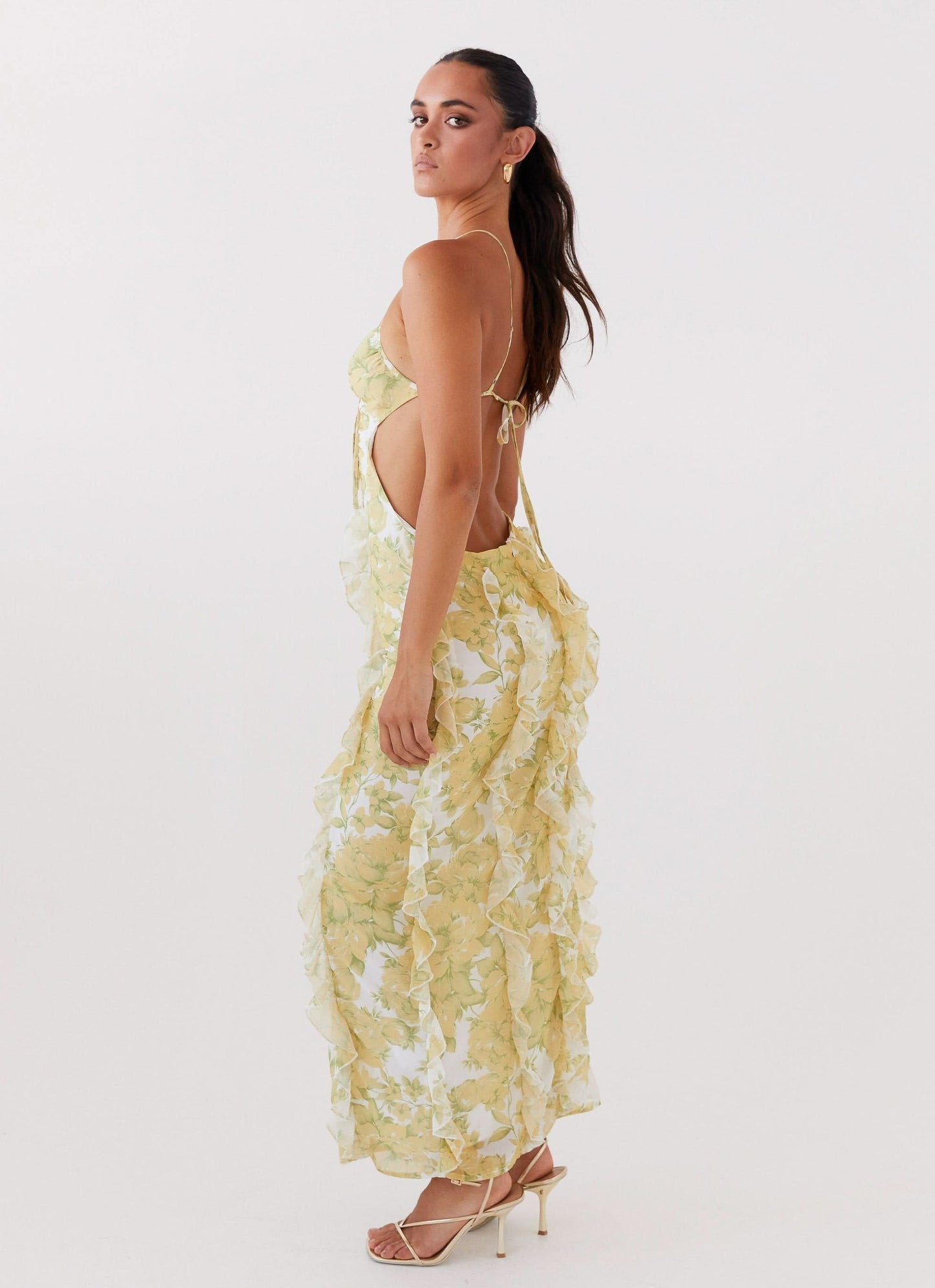 Open backless maxi dress in pale yellow floral print with tie closure detail